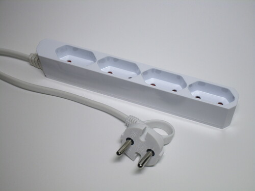 View of the power strip and its plug. The power strip is made to be very thin, while the plug has the cord coming from the side and a ring to help remove it.