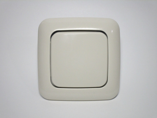 Standard European light switch. It has a large surface which is pushed up or down to toggle the lights.