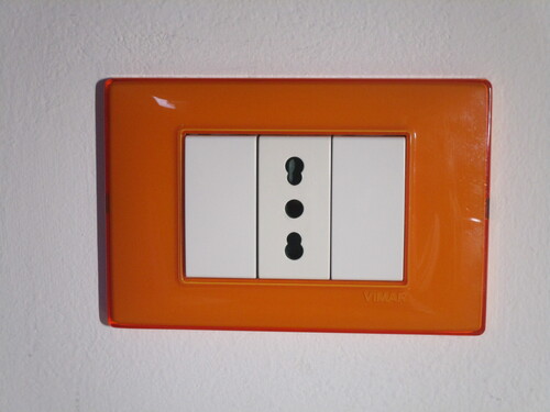 Bipasso power socket from Vimar. The socket has an orange faceplate.