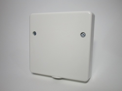 Front view of the connection unit. It's a white plastic box with two screws on the front.