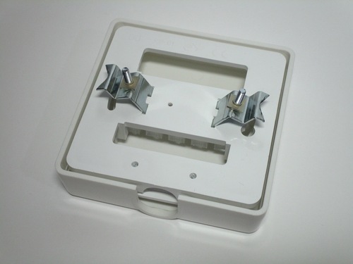 Rear view of the connection unit. The mounting holes and 'claws' are visible.