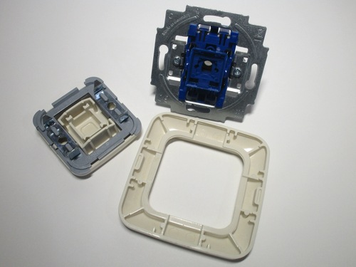 The three components of the switch: the mechanism, key cover and cover plate.