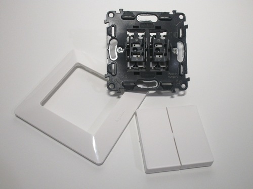 Components of the switch: the key covers can be removed for easier wiring, and the faceplate is added later.