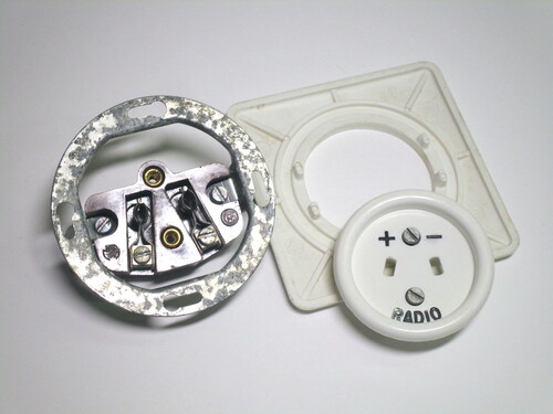 The radio connector, disassembled. The faceplate is formed of two pieces.