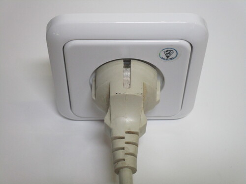 CEE 7/7 Schuko plug inside an Israeli socket. The earth contacts on the side of the plug aren't connected in any way.