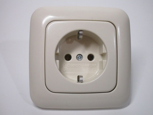 Front view of the Busch-Jaeger socket. It's beige and with rounded corners.