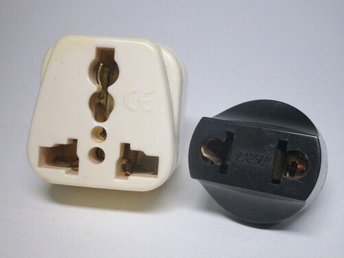 Examples of two travel adaptors with wide contacts, which form a poor connection.