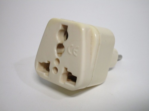 Front view of the adaptor. The adaptor has large holes used to accomodate different standards of plug.